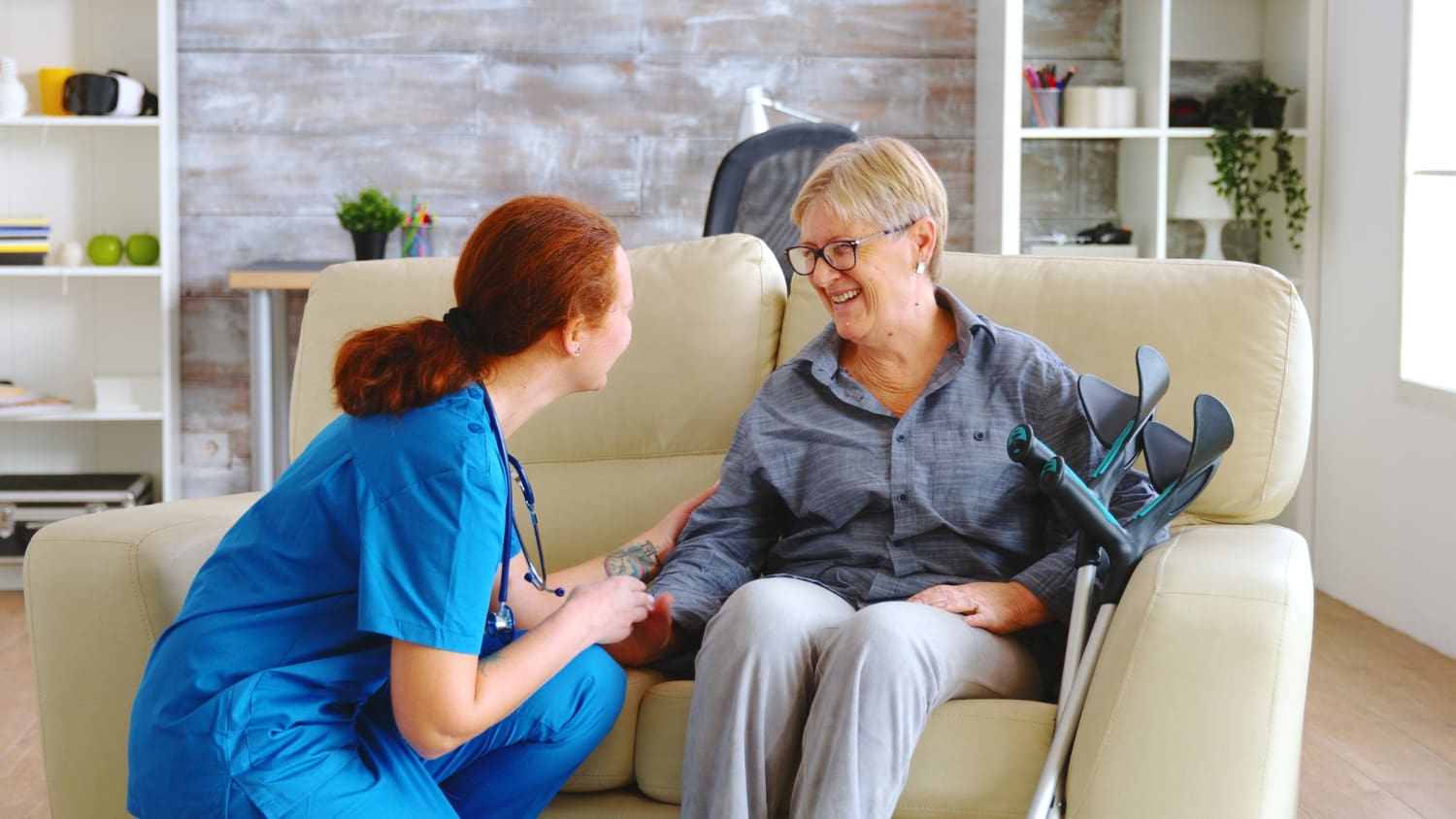 Healthcare professional smiling with elderly woman at home, discussing In-Home Supportive Services with a focus on independence and safety, provided by All Seniors Foundation in California.